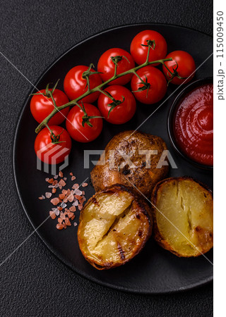 Delicious halved potatoes grilled with salt, spices and herbs 115009450
