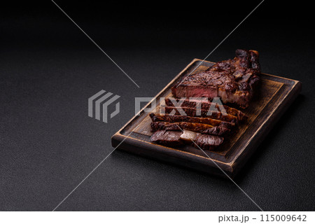 Delicious juicy beef ribeye steak grilled with salt, spices and herbs Delicious juicy beef ribeye steak grilled with salt, spices and herbs 115009642