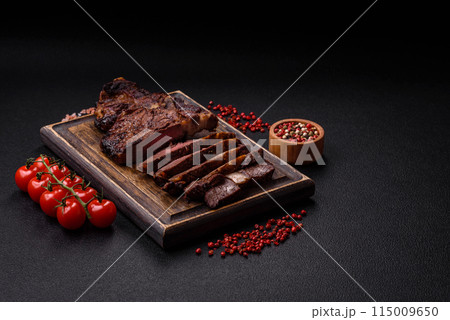 Delicious juicy beef ribeye steak grilled with salt, spices and herbs 115009650