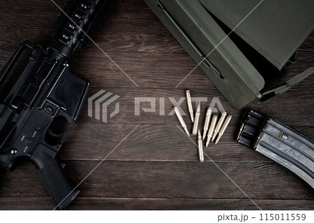 Rifle and Ammunition with magazine on wooden table Rifle and Ammunition with magazine on wooden table 115011559