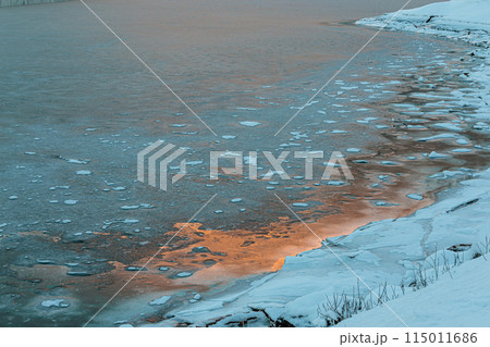 The freezing water of a fjord in the early evening light of the beginning winter, Lofoten, Norway 115011686