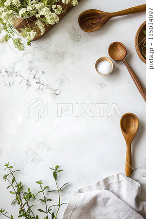 A white background with a few spoons and a salt shaker 115014097