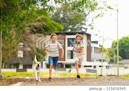 Kids play with dog. Children and puppy run in park Kids play with dog. Children and puppy run in park 115018343