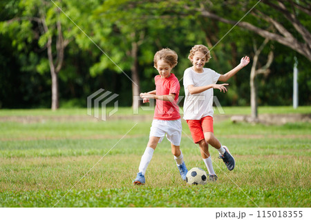Child playing football. Kids play soccer. Child playing football. Kids play soccer. 115018355