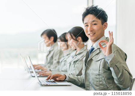 デスクワークする作業着・作業服姿の男女ビジネスマン・エンジニア(ok・安心・安全・信頼) デスクワークする作業着・作業服姿の男女ビジネスマン・エンジニア(ok・安心・安全・信頼) 115018850