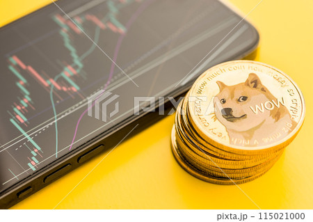 Dogecoin gold coin. Cryptocurrency and business chart in cellphone. Dogecoin gold coin. Cryptocurrency and business chart in cellphone. 115021000