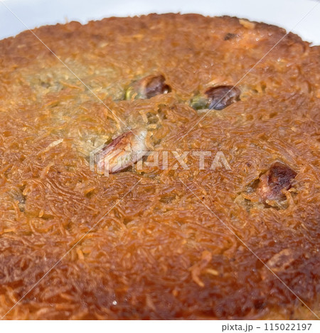 Traditional Turkish dessert, Kunefe.With pistachio and close-up. Traditional Turkish dessert, Kunefe.With pistachio and close-up. 115022197