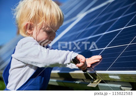 Boy learning how does solar panel work. Small kid interested in using different tools. Curious boy helping to tighten the screw. Boy learning how does solar panel work. Small kid interested in using different tools. Curious boy helping to tighten the screw. 115022583