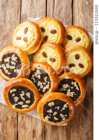 Czech and Slovak Kolach or kolace type of sweet yeast pastry filling with cottage cheese, poppy seeds closeup. Vertical top view 115022680