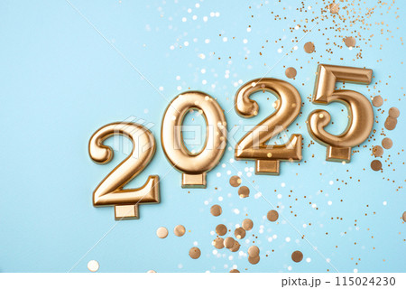 Golden 2025 on a blue color background with confetti and bokeh lights. Happy New Year 2025 is coming concept. Top view. Golden 2025 on a blue color background with confetti and bokeh lights. Happy New Year 2025 is coming concept. Top view. 115024230