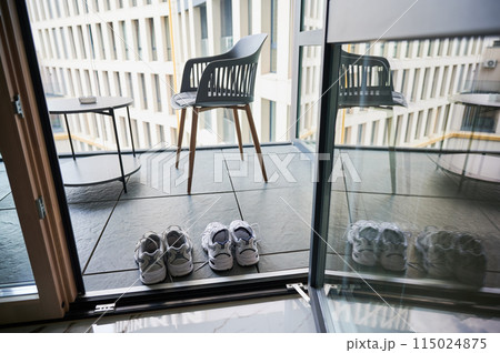 Two pairs of sneakers shoes drying on balcony. Matching white sneakers for man and woman. Two pairs of sneakers shoes drying on balcony. Matching white sneakers for man and woman. 115024875