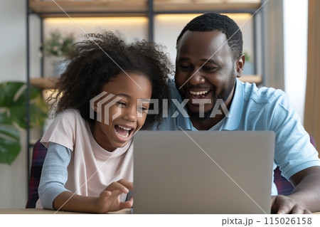 Happy father and child at laptop. Daddy and daughter having fun. 115026158