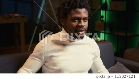 African american gamer winning game after killing all foes in game, punching air from happiness. Joyful player celebrating, feeling excited after being victorious in SF videogame 115027121