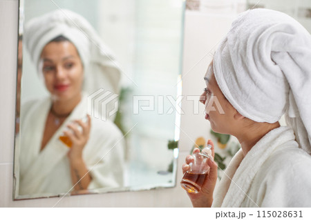 Woman Applying Fragrance on Neck 115028631