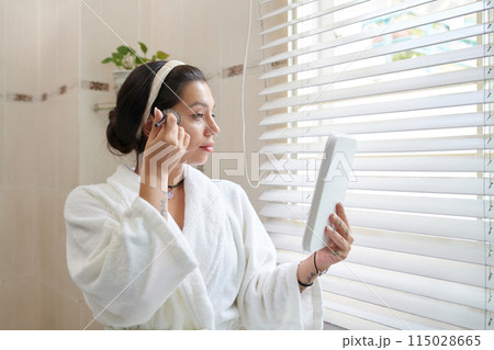 Woman in Bathrobe Applying Makeup Woman in Bathrobe Applying Makeup 115028665