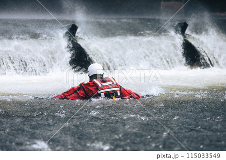 Firefighter during a drowning rescue training. Firefighter during a drowning rescue training. 115033549