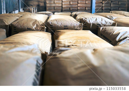 Warehouse full of paper sacks with tea. 115033558