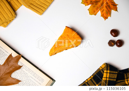 Pumpkin pie flat lay for fall concept, top view. Top view of pumpkin pie with autumn leaves, chestnut. White background. Hello autumn concept 115036105