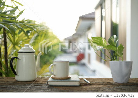 white enamel teapot and white ceramic cup 115036418