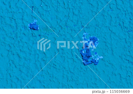 Hole in the wall close-up ruined broken damaged construction texture blue paint surface 115036669
