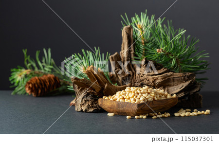 Peeled pine nuts with cedar dried snags and green branches. 115037301