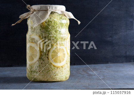 Elder flowers drink glass. White flower shrub. Harvesting buds for making syrup and drink. Cooking drinks. 115037916