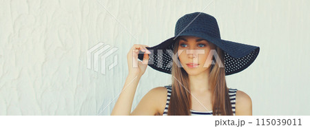 Portrait of beautiful blonde young woman in summer straw hat on white background 115039011