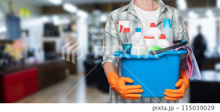 Cleaning woman with a bucket of cleaning products . 115039029