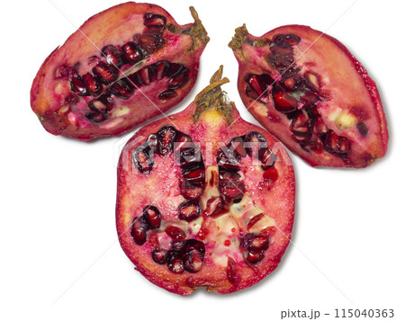 Sliced pomegranate on a white background. Juicy fruit with seeds. Pieces of red fruit. Juicy pulp. Pomegranate isolate. Juice ingredient. 115040363