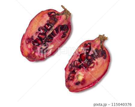 Sliced pomegranate on a white background. Juicy fruit with seeds. Pieces of red fruit. Juicy pulp. Pomegranate isolate. Juice ingredient. Sliced pomegranate on a white background. Juicy fruit with seeds. Pieces of red fruit. Juicy pulp. Pomegranate isolate. Juice ingredient. 115040376