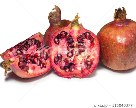 Sliced pomegranate on a white background. Juicy fruit with seeds. Pieces of red fruit. Juicy pulp. Pomegranate isolate. Juice ingredient. Sliced pomegranate on a white background. Juicy fruit with seeds. Pieces of red fruit. Juicy pulp. Pomegranate isolate. Juice ingredient. 115040377