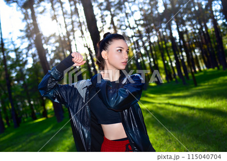 Fitness woman exercising in the park in early spring on fresh air. 115040704