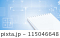 The open spiral-bound notebook on a blue futuristic background with business and education elements. 115046648
