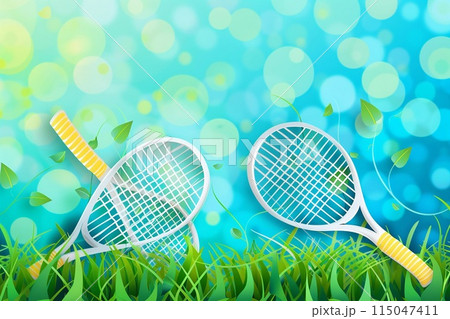 tennis rackets crossed on a grass court 115047411