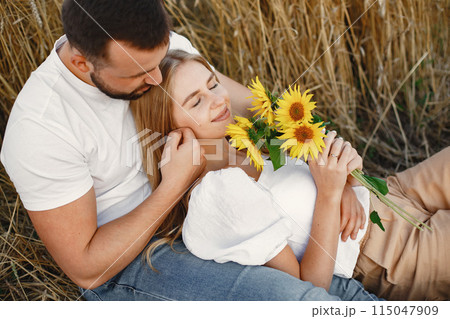 Cute couple in a field. Lady in a white blouse. Guy in a white shirt 115047909