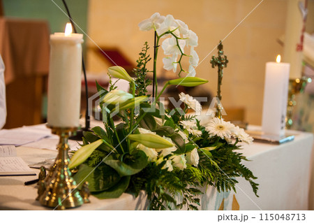 Create a classy ambiance with flowers, candles, and gentle lighting for a serene setting 115048713