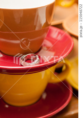 Engagement Ring featured on Colorful Coffee Cups in Vibrant Image for Stock Media Engagement Ring featured on Colorful Coffee Cups in Vibrant Image for Stock Media 115048722