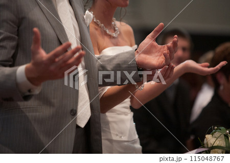 Bride and groom at wedding ceremony prayers, symbolizing commitment, love, and union Bride and groom at wedding ceremony prayers, symbolizing commitment, love, and union 115048767