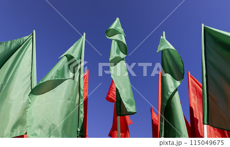 green flags set up during the celebration in windy weather green flags set up during the celebration in windy weather 115049675