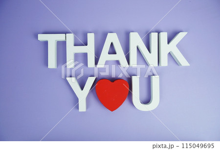Thank You alphabet letters top view on purple background Thank You alphabet letters top view on purple background 115049695