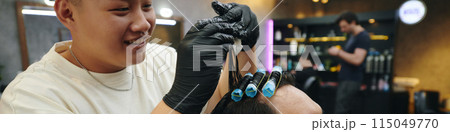 Hairdresser Putting Rollers in Wet Hair 115049770