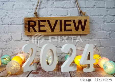 Review 2024 letters with LED cotton balls decoration on wooden background Review 2024 letters with LED cotton balls decoration on wooden background 115049879