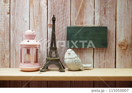 Empty wooden hanging on wooden background with eiffel tower home decor on wooden shelve 115050007