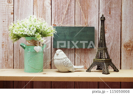 Empty wooden hanging on wooden background with eiffel tower on wooden shelve 115050008
