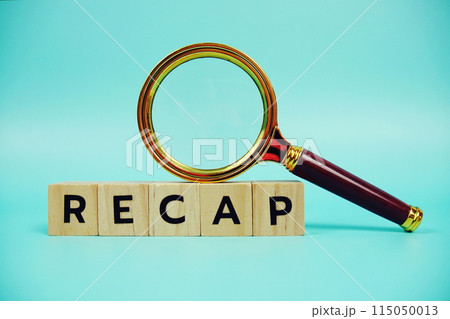 Recap with wooden blocks alphabet letters and Magnifying glass on blue background 115050013