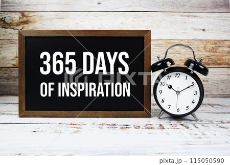 365 days of inspiration quotes text message and alarm clock on wooden background 115050590