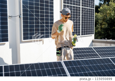 Man on a rooftop with solar panels 115050899