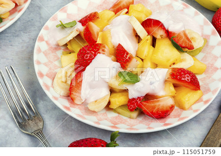 Fruit salad with yogurt on a plate. Fruit salad with yogurt on a plate. 115051759