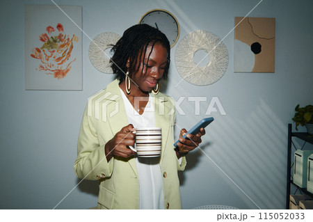 Businesswoman Checking Notifications on Smartphone Businesswoman Checking Notifications on Smartphone 115052033