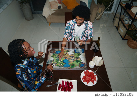 Black Couple Playing Board Game 115052109
